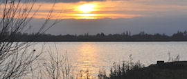 The sun setting on a lake in Huntingdon